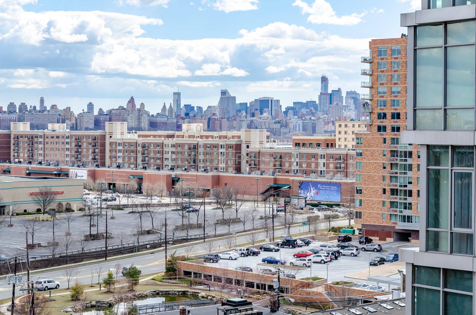 Manhattan Skyline with office Buildings and parking lot of Cliffside Park New Jersey in the front during a sunny winter day, horizontal