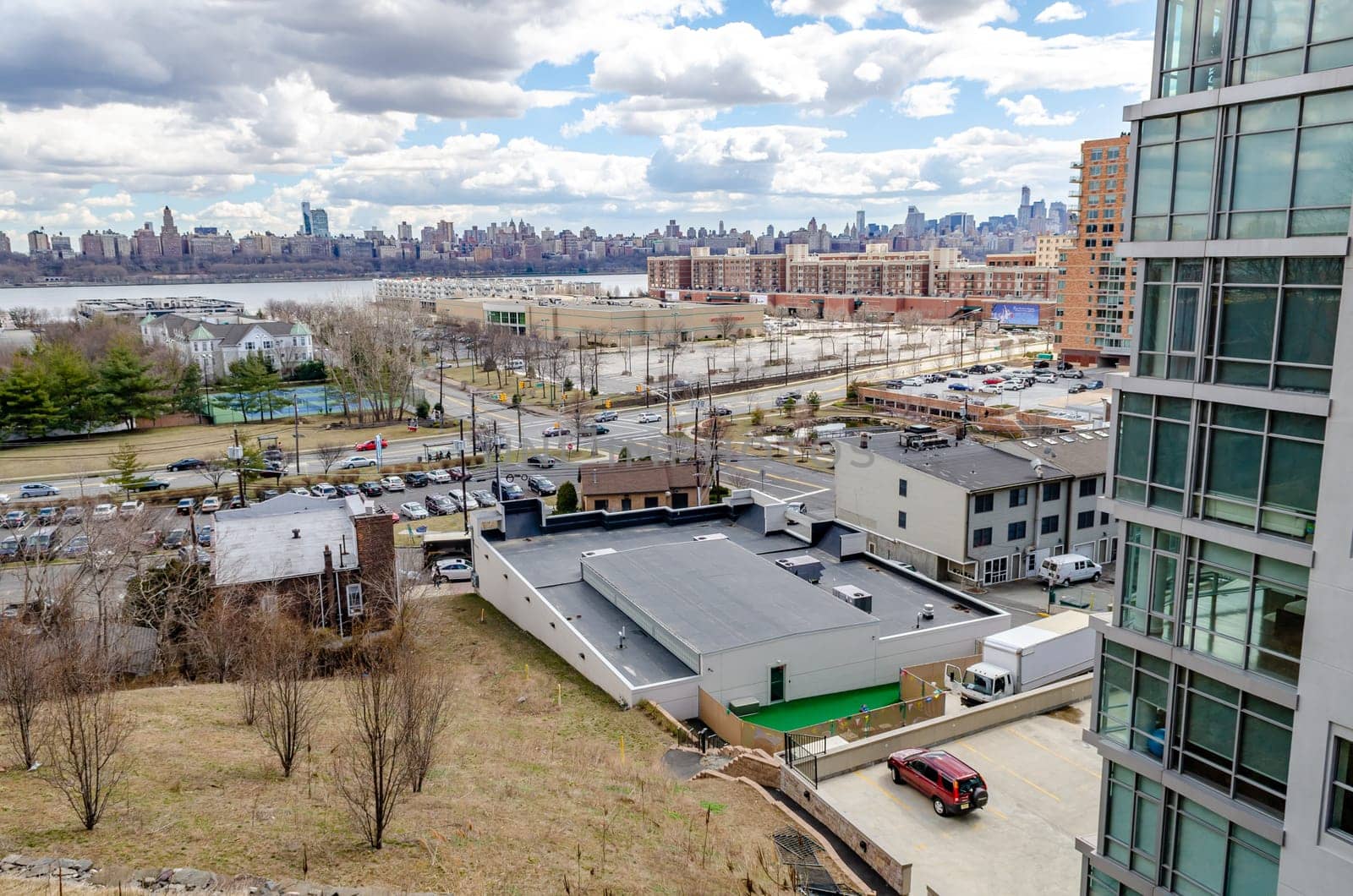 Harlem, Manhattan Skyline on the other side of Hudson river with Cliffside Park New Jersey in the forefront during a sunny winter day, horizontal