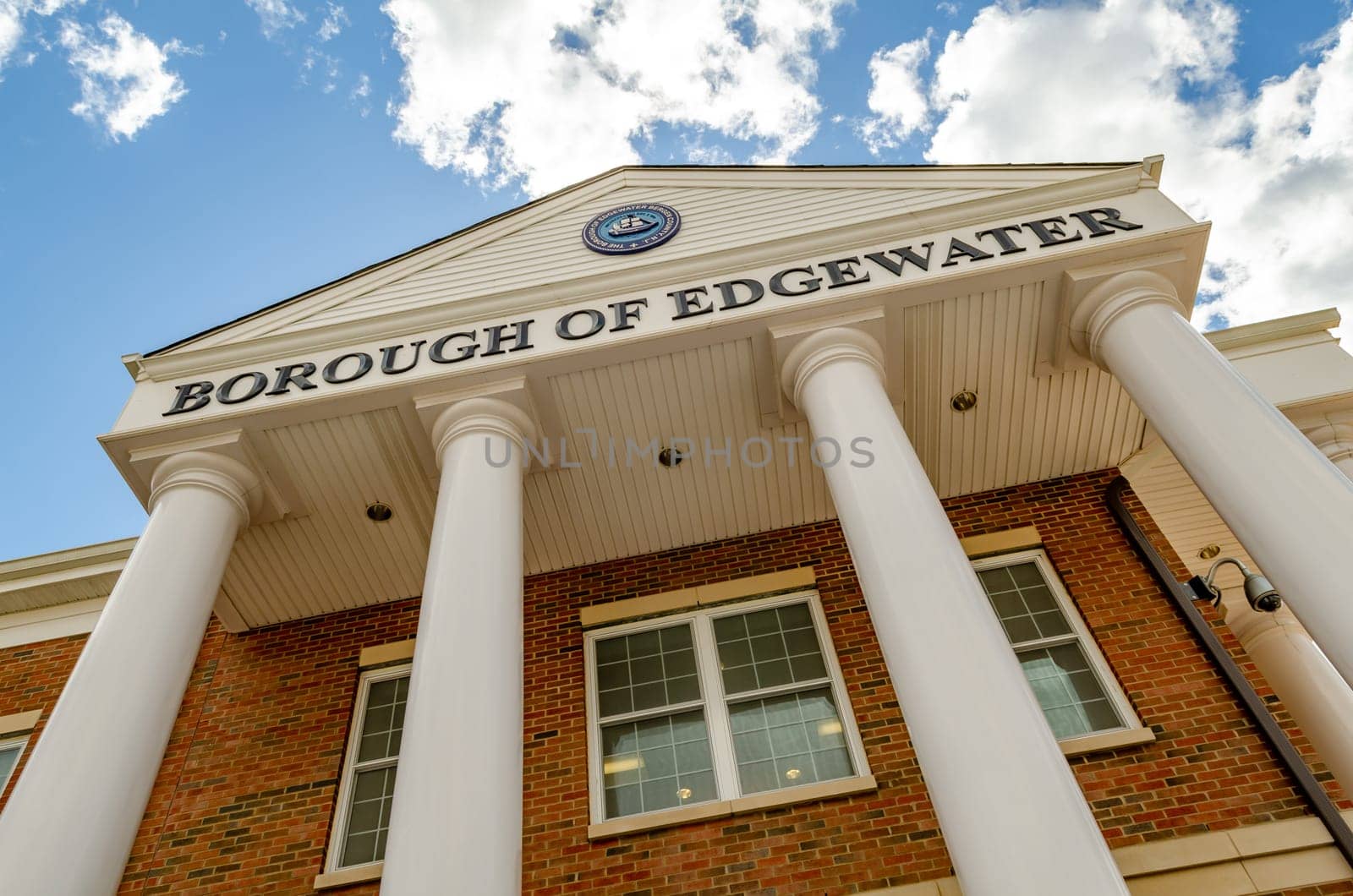 Edgewater Borough Hall, Bergen County, New Jersey Building with columns, low angle view, during a sunny winter day, Lights inside the Building, horizontal