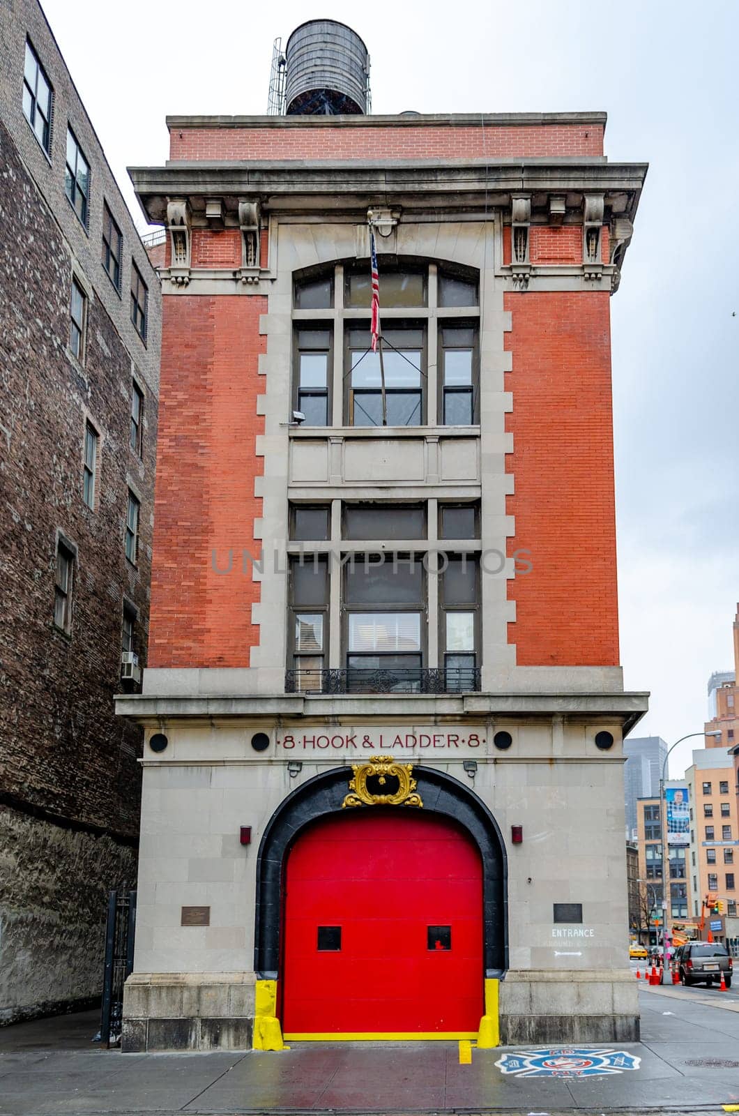 FDNY Ladder 8, Manhattan, New York City view from low angle, during rainy winter day with overcast, front view, vertical