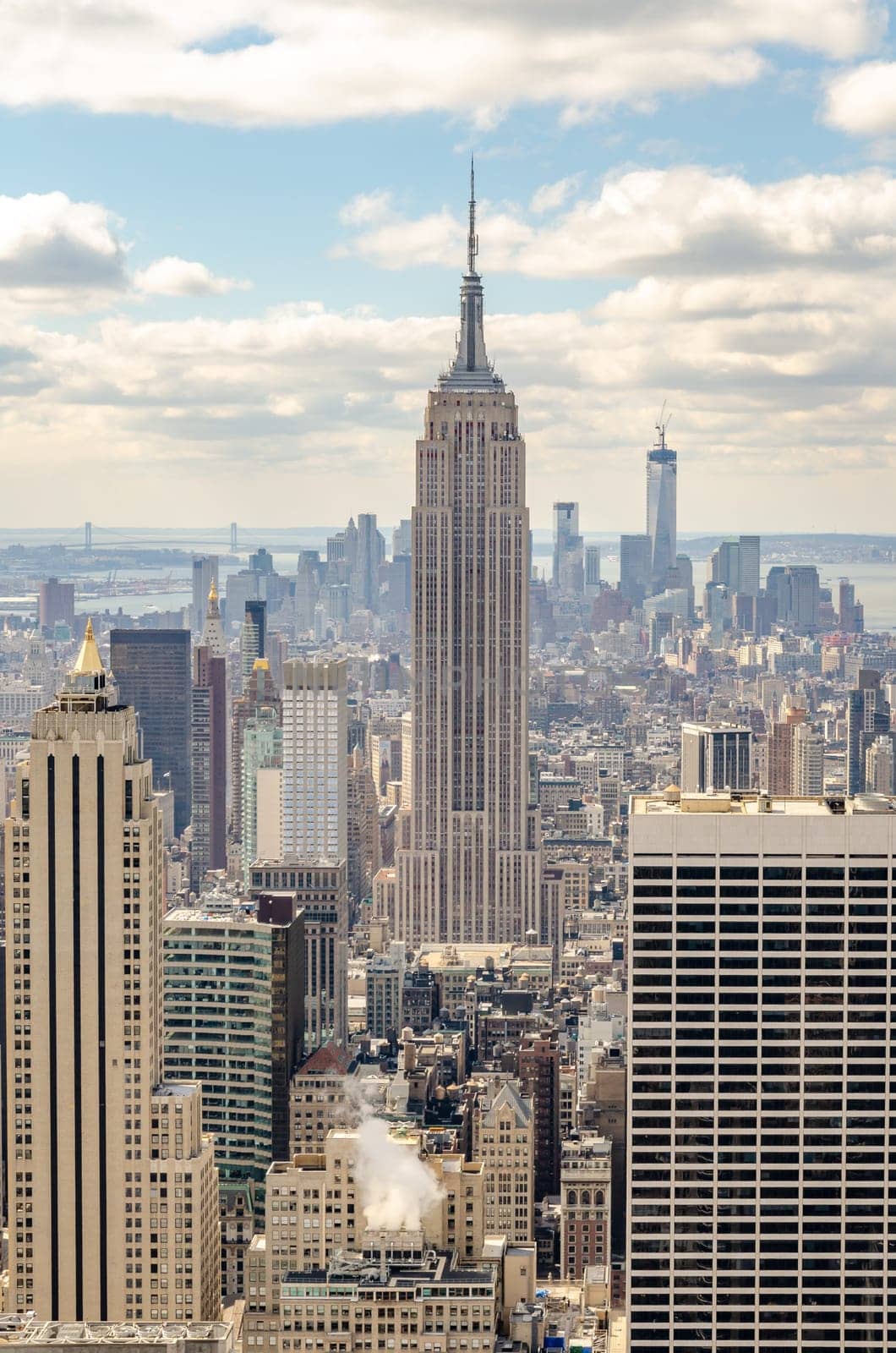 Empire State Building Aerial View from Rockefeller Center with One World Trade Center construction site in the background, New York City during winter, vertical