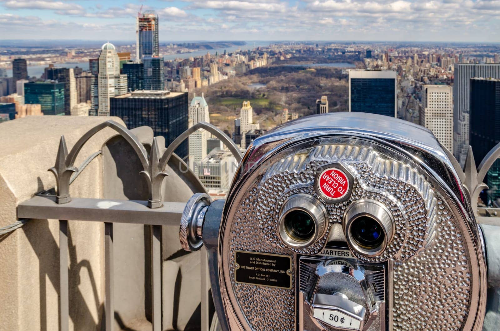 Central Park New York City aerial view from Rockefeller Center with binoculars and fence in the front, during winter, horizontal