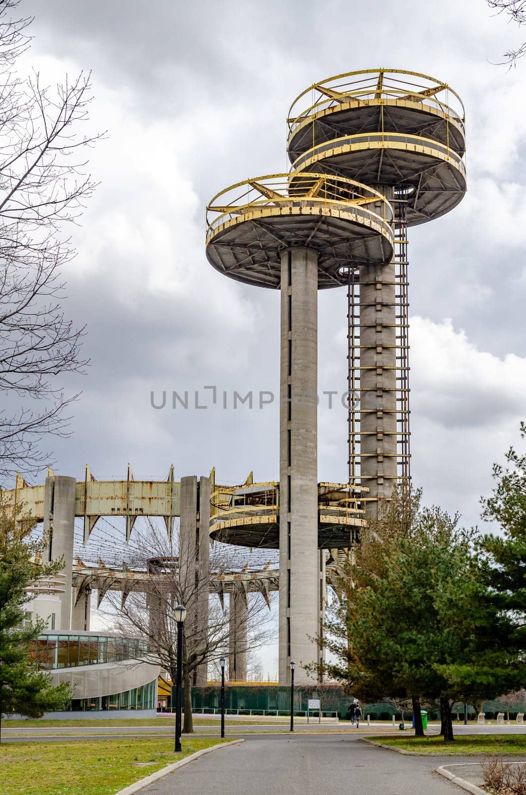 New York State Pavilion Observation Towers with Queens Theatre, way and trees in front, Flushing-Meadows-Park, New York City during overcast winter day, vertical