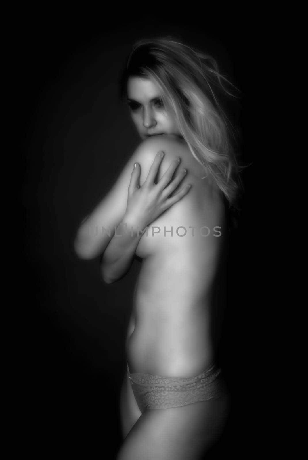 Soft focus infrared black and white sensual beautiful woman with perfect body posing nude