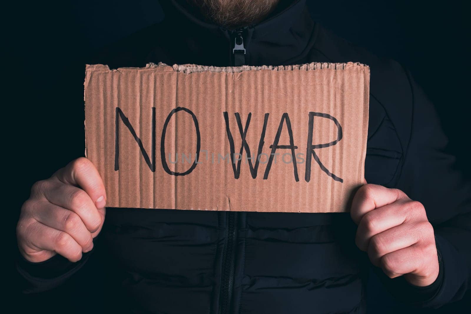 Man holding placard No war text. Freedom to Ukraine concept.