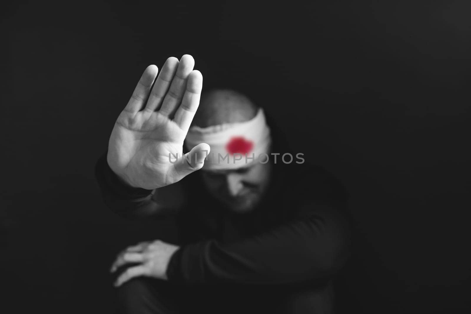 Wounded man showing stop gesture. Stop war, russian aggression, freedom to Ukraine concept.
