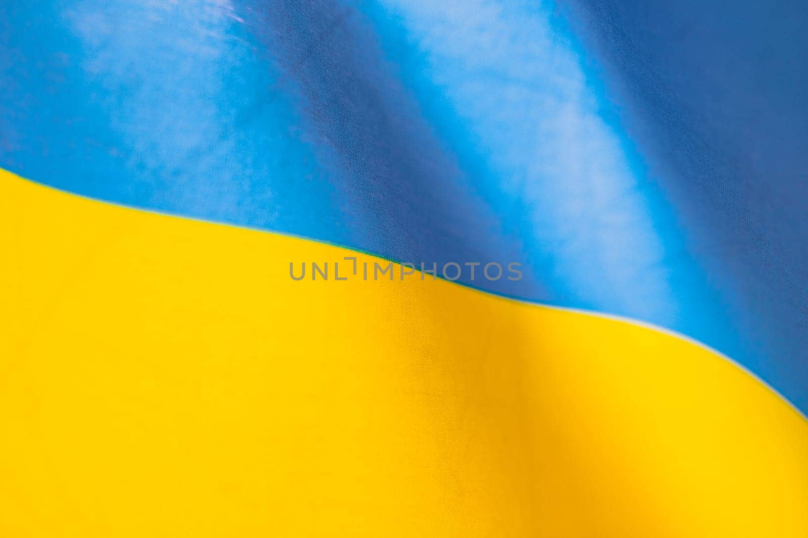 Flag of Ukraine, UA. Blue and yellow colors. Close up shot, background