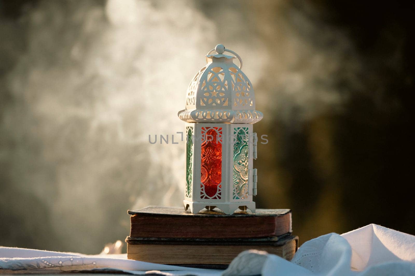 Ramadan Kareem background. Ornamental Arabic lantern glowing at night and the Quaran.