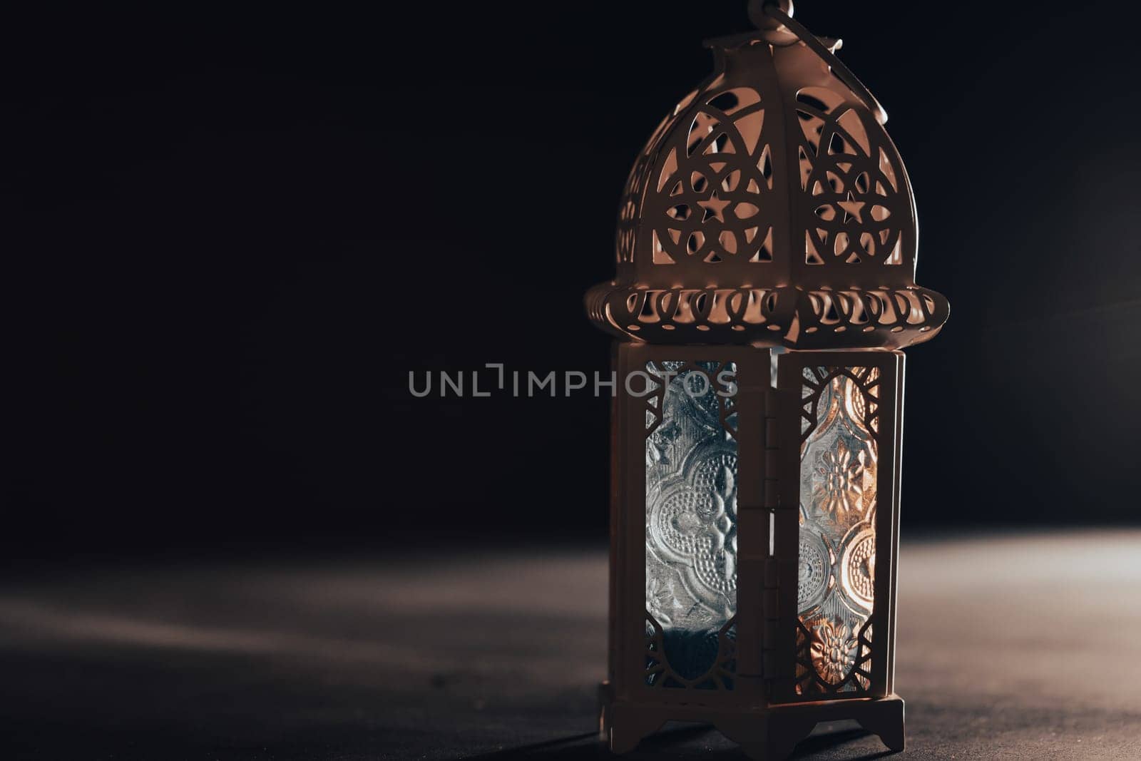 Ramadan Kareem background. Ornamental Arabic lantern glowing at night