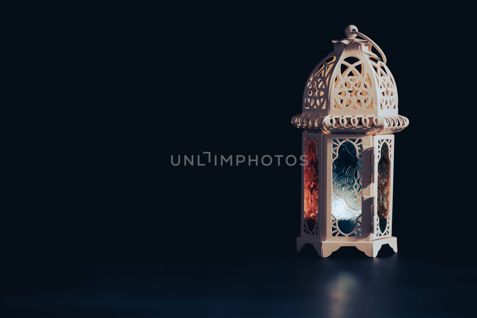 Ramadan Kareem background. Ornamental Arabic lantern glowing at night