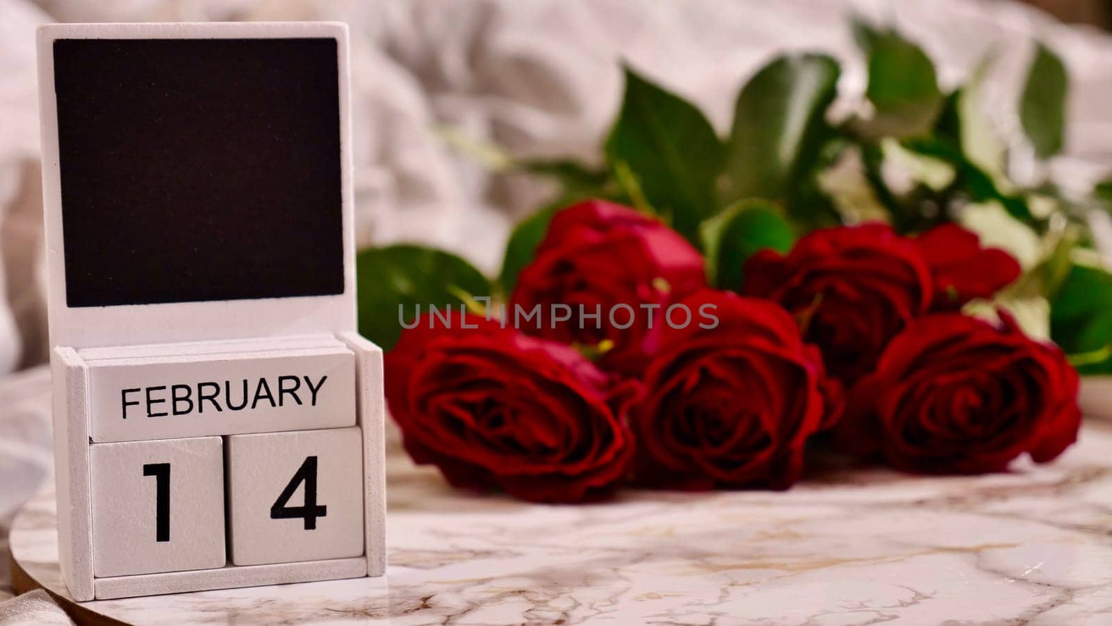 Festive Flatlay, composition for Valentine's Day on February 14. Coffee in a red cup and red rose flowers at home in bed