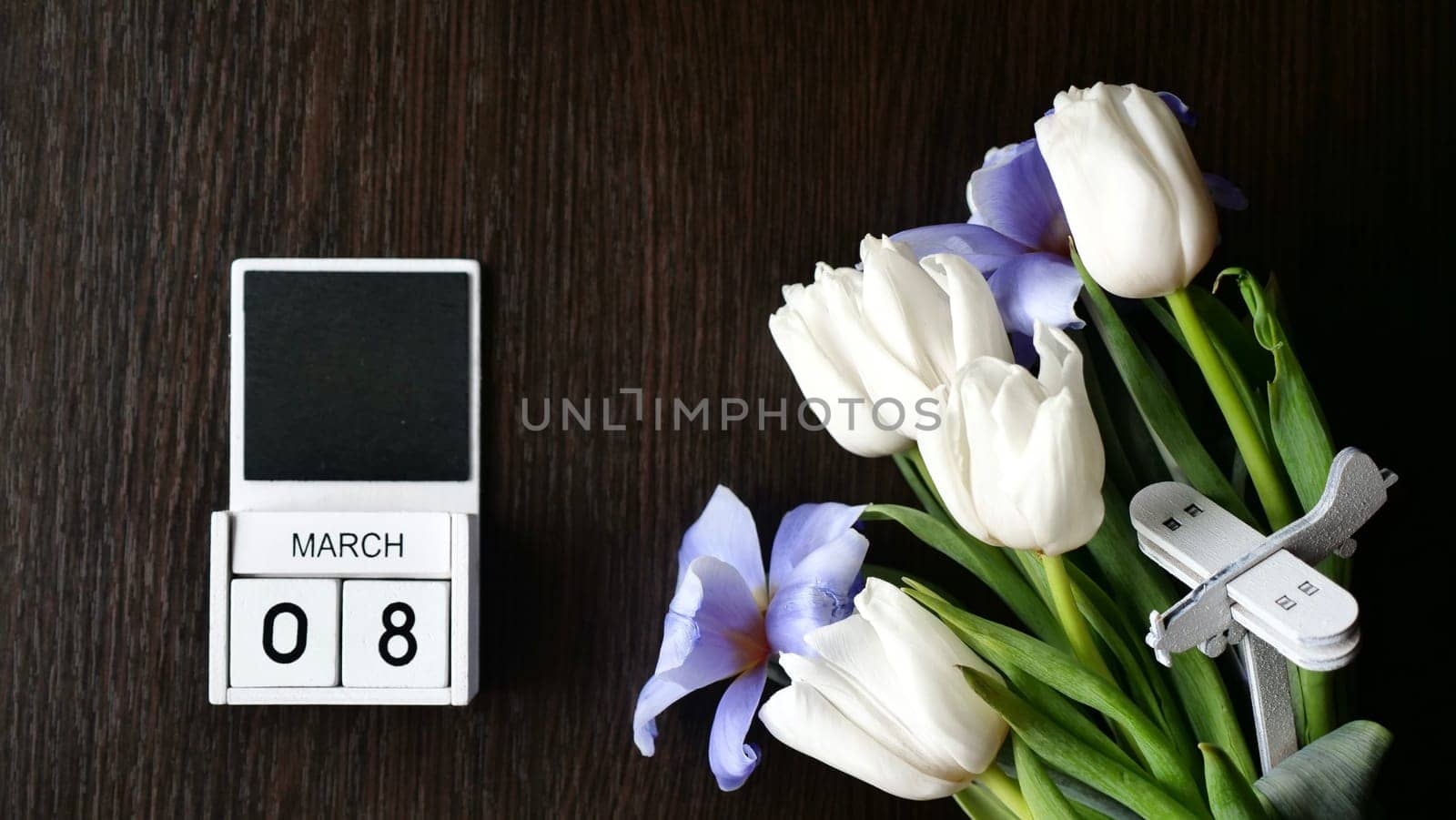 International Women's Day is March 8 on the calendar. Spring flowers tulips - white and blue. insert text