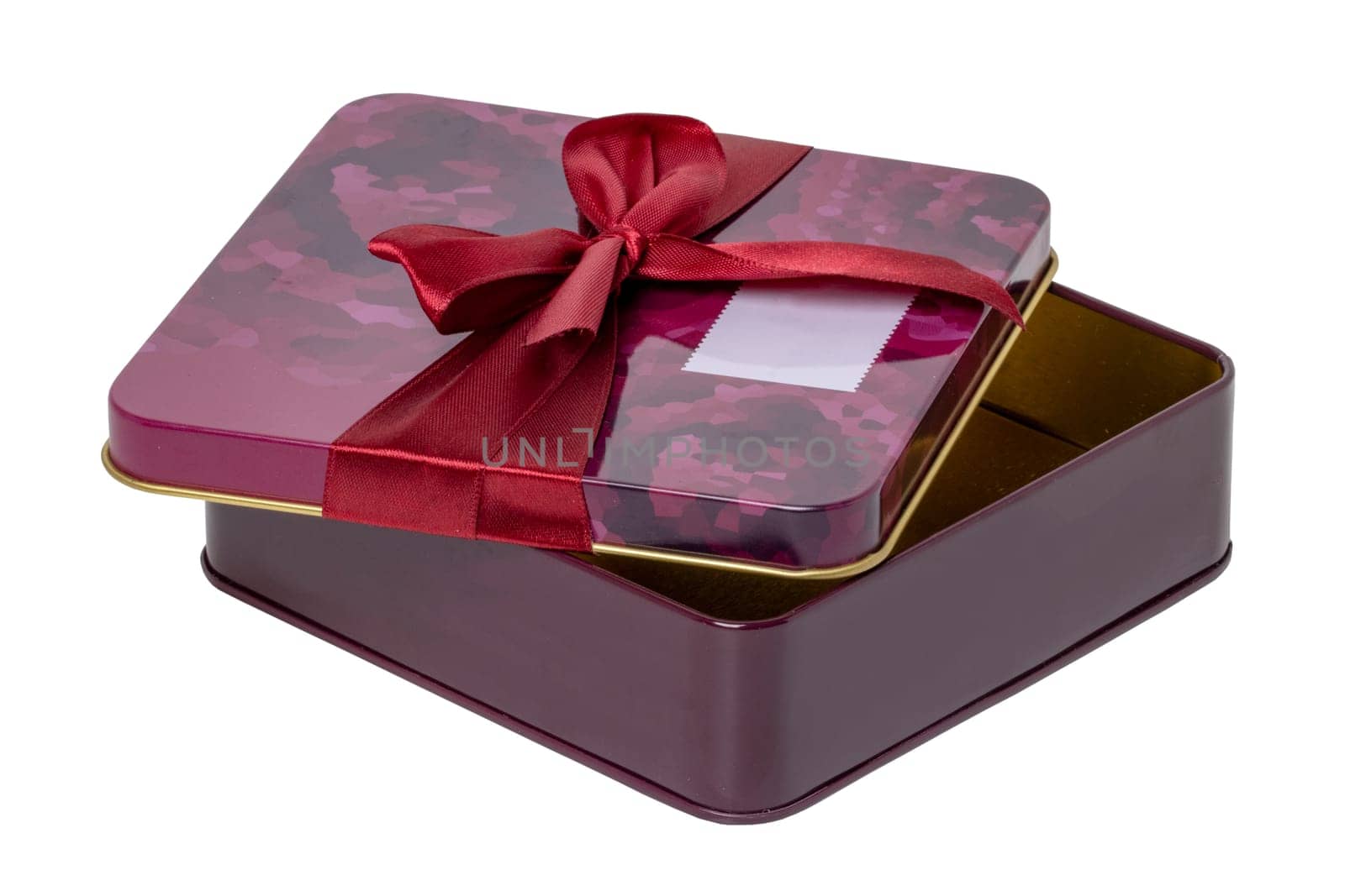 Closeup of a decorative red pink present or gift box with ribbon bow isolated on a white background. Birthday, Christmas, Valentine's Day. Clipping path. Macro.