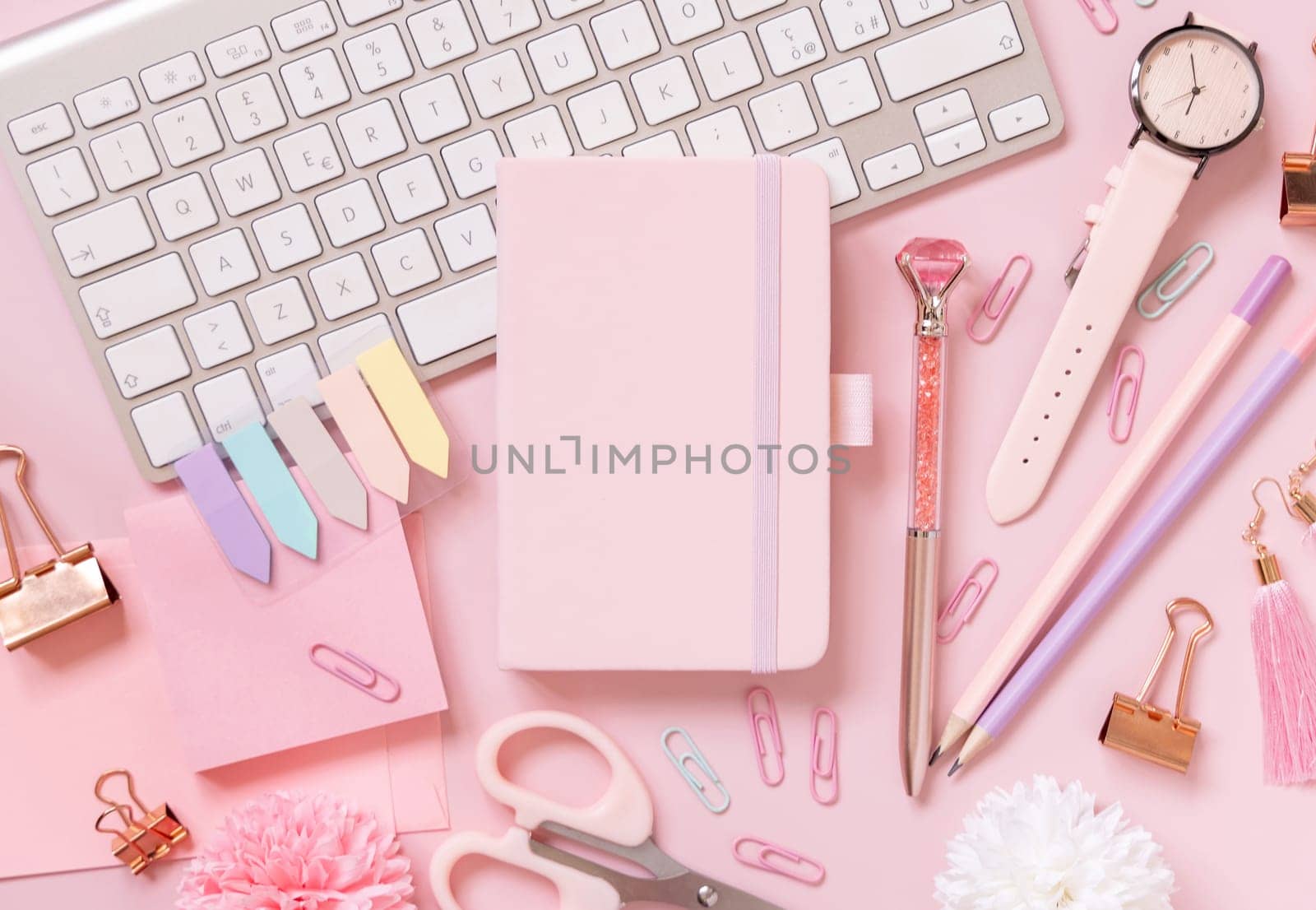 Hardcover notebook, Pink school accessories and keyboard on light pink, Top view, textbook mockup. Girly workplace with notebook, scissors, pencil, pen, paperclips, cards and watch. Back to school