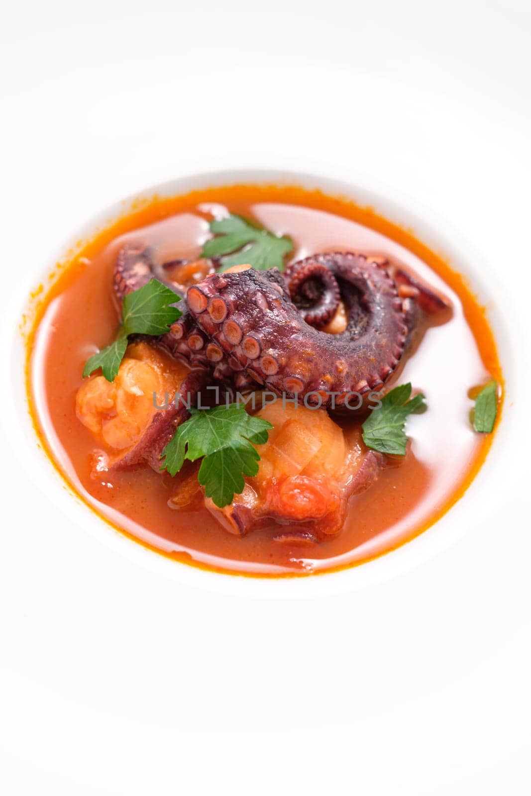Stewed octopus and tomato with parsley in a restaurant