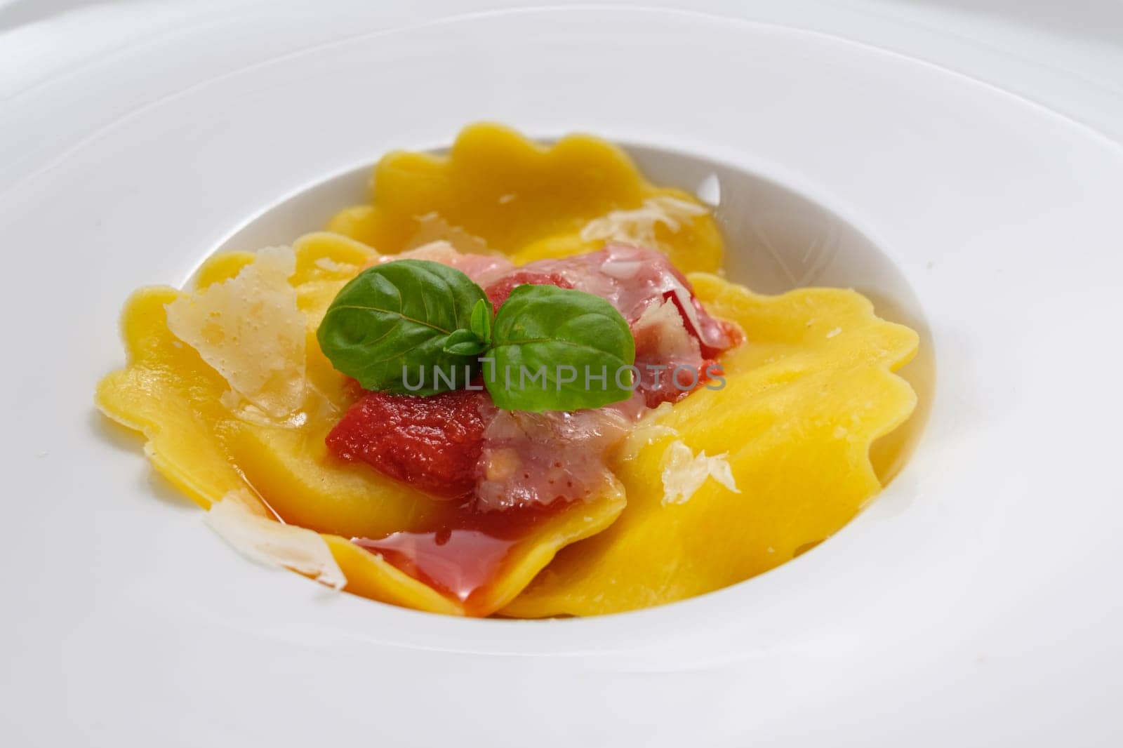 Tortetllini pasta with green basil and red tomato sauce