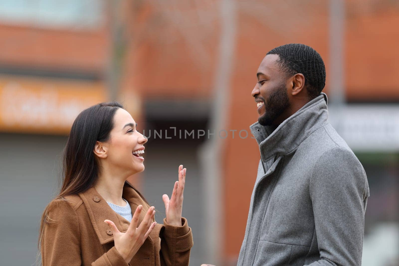 Interracial relation with woman and man talking in the street