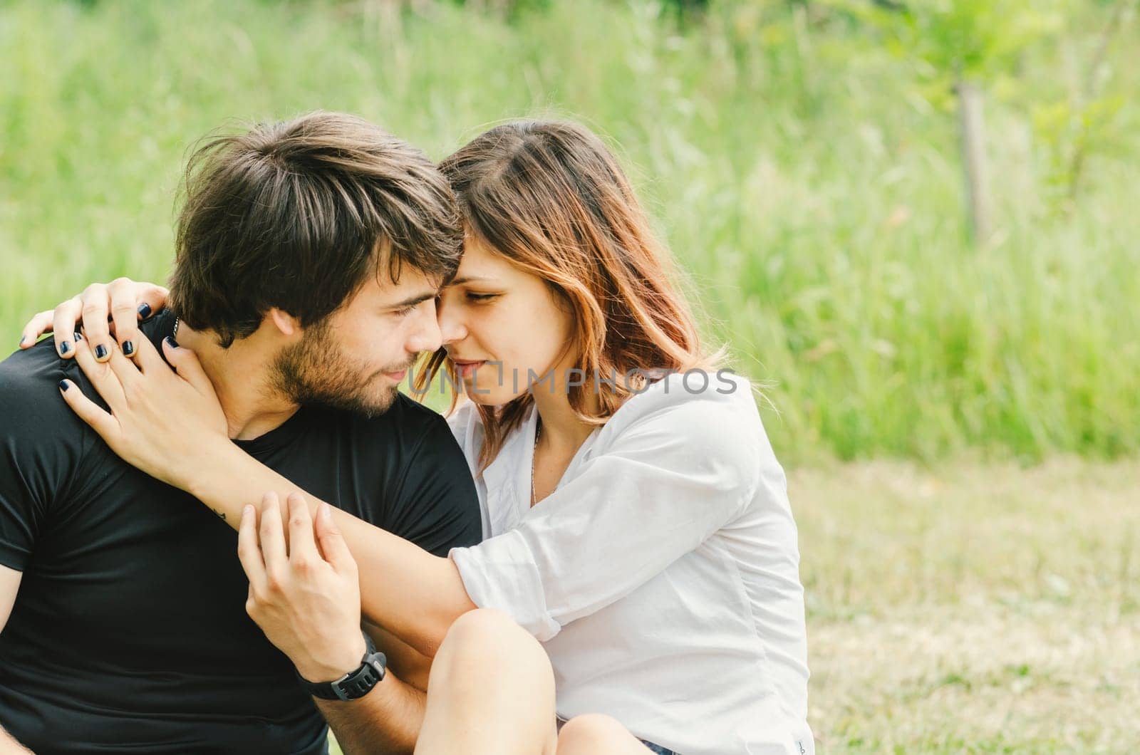 Happy couple hugging in nature