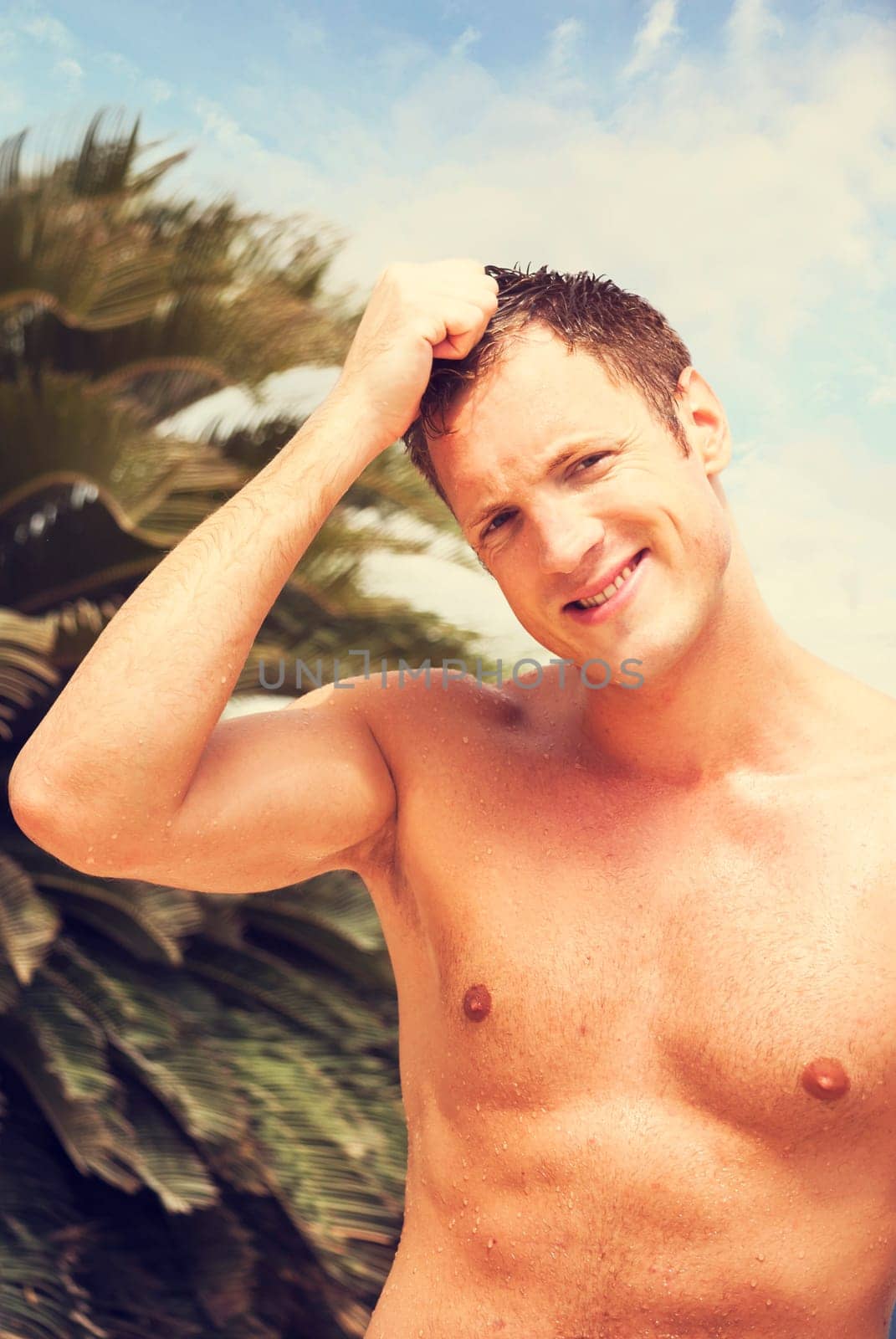 Portrait of handsome blond man at tropical beach. retro filter.