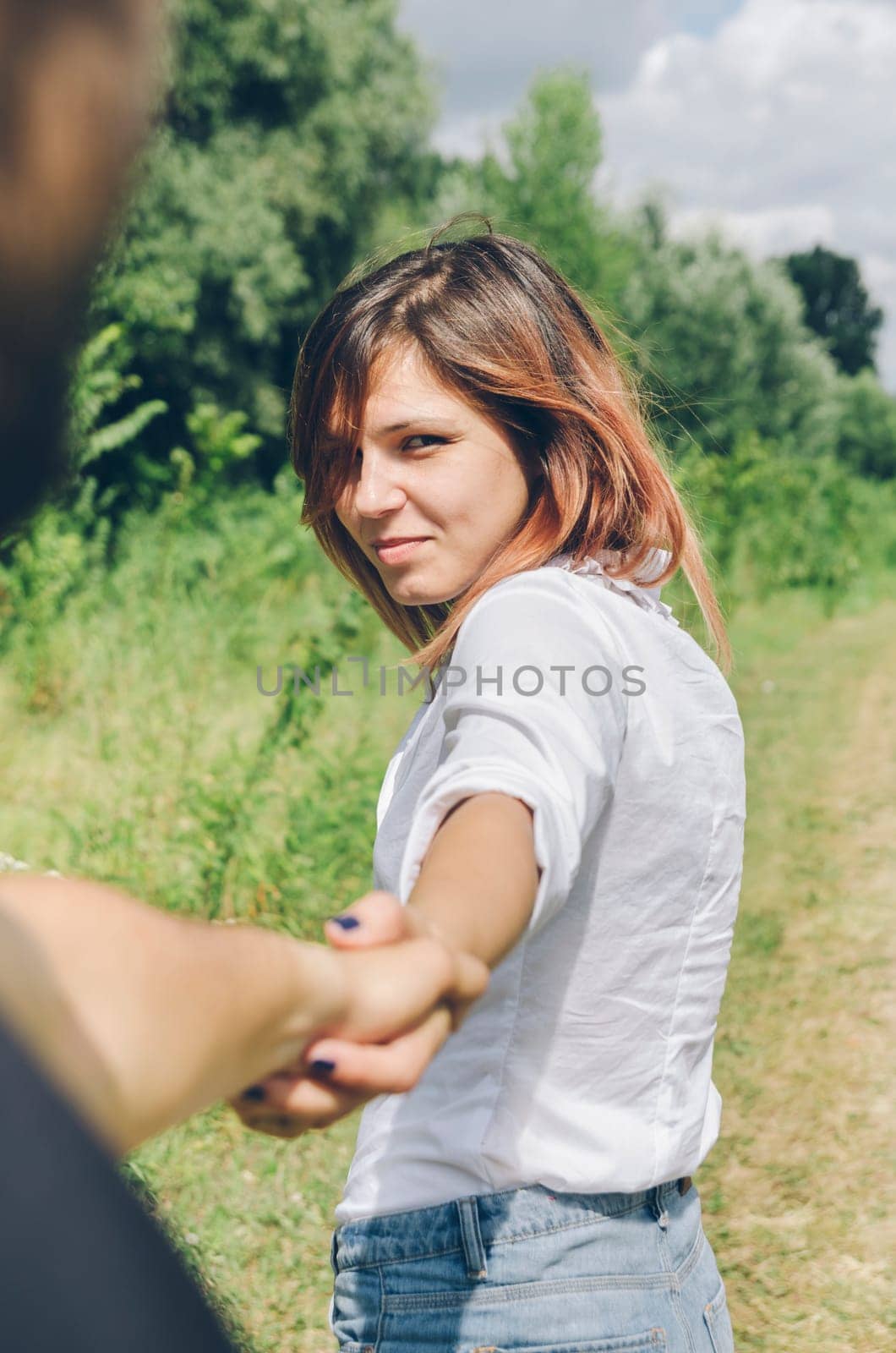 Young couple holding hands and hiking