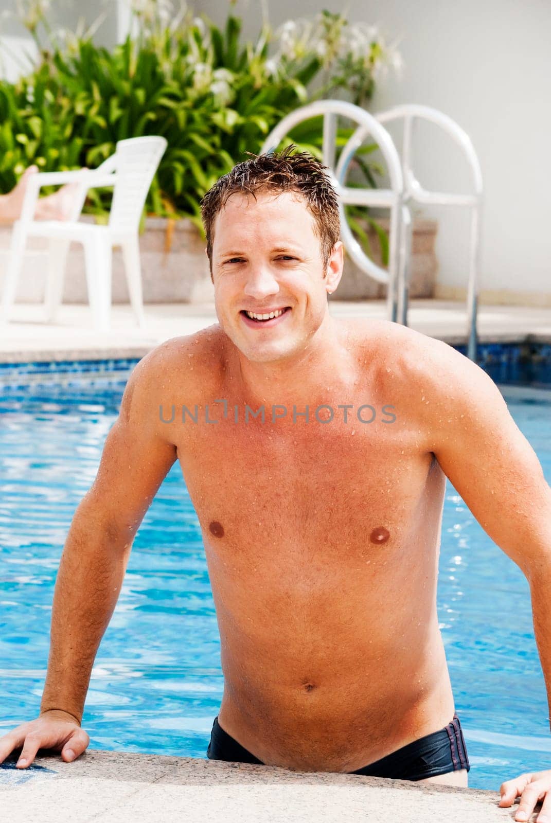 Handsome blond man in the swimming  pool