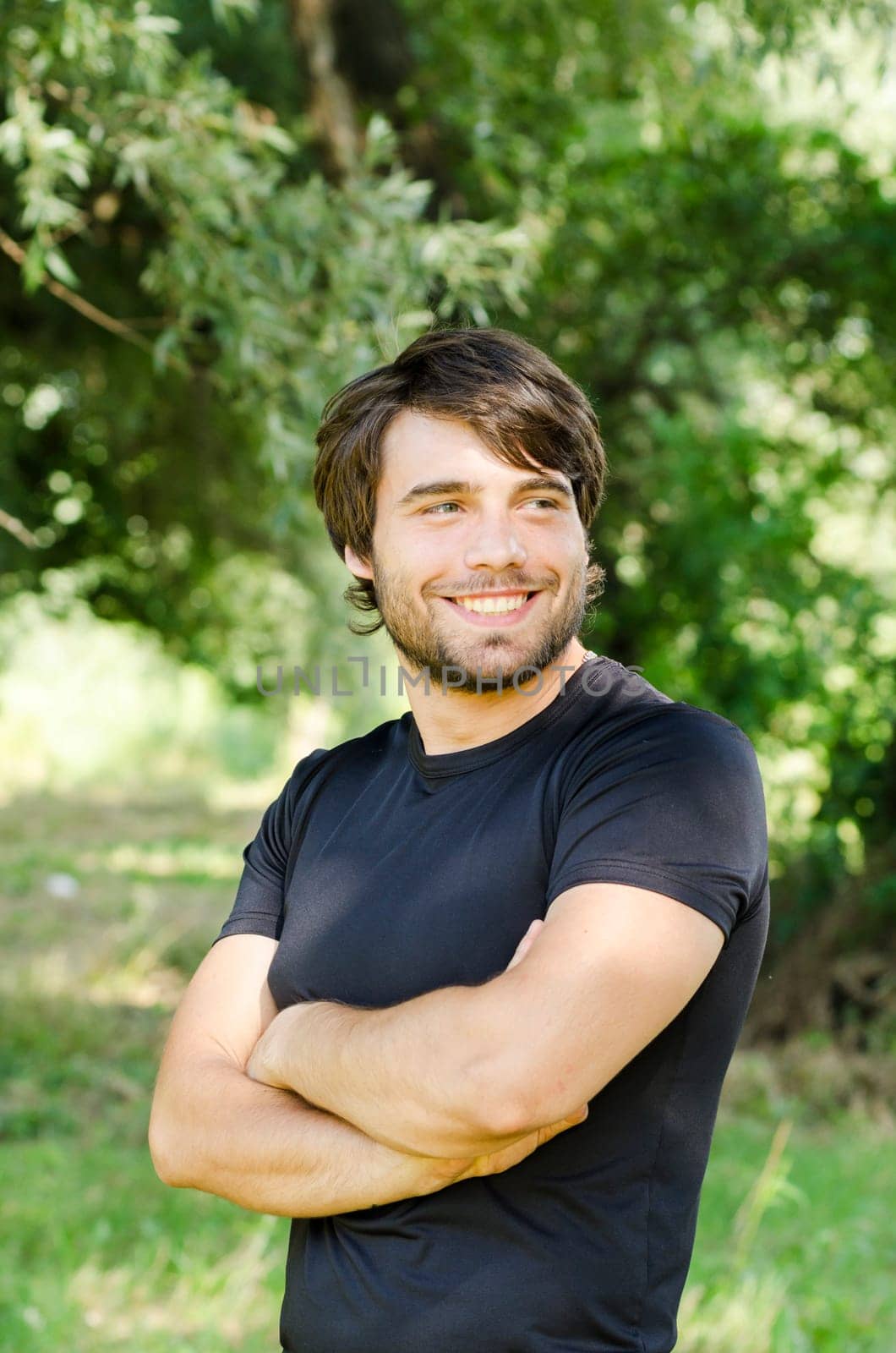 Happy young man smiling in nature