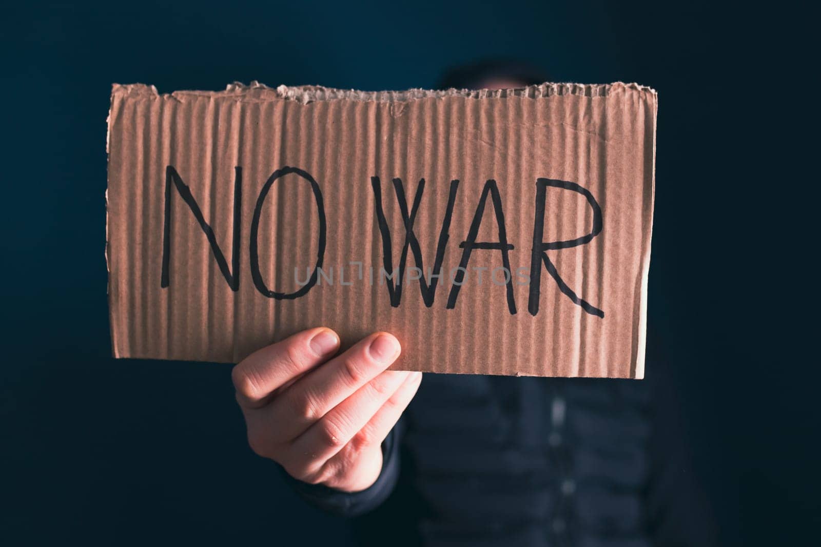 Man holding placard No war text. Freedom to Ukraine concept.