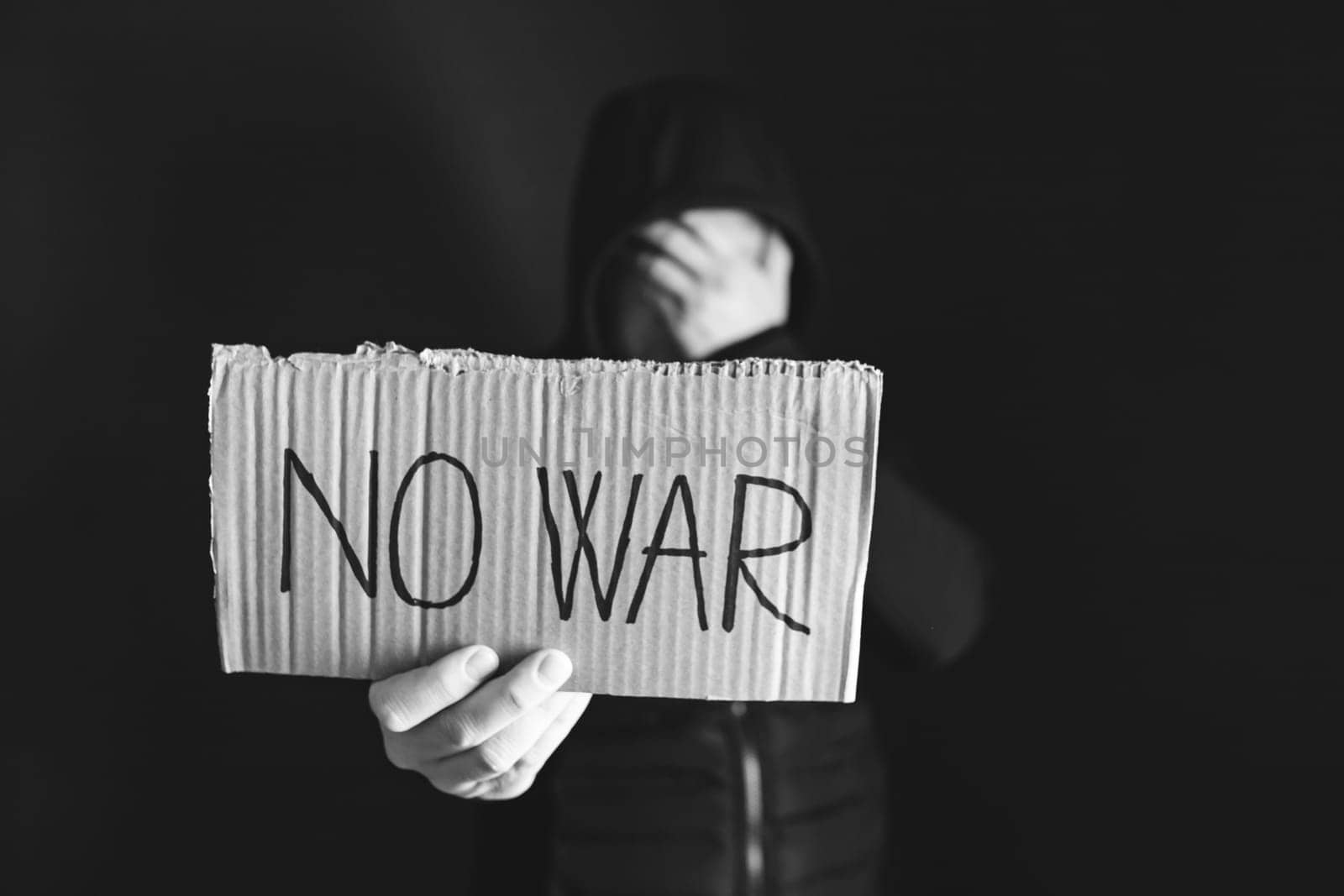 Man holding placard No war text. Freedom to Ukraine concept.