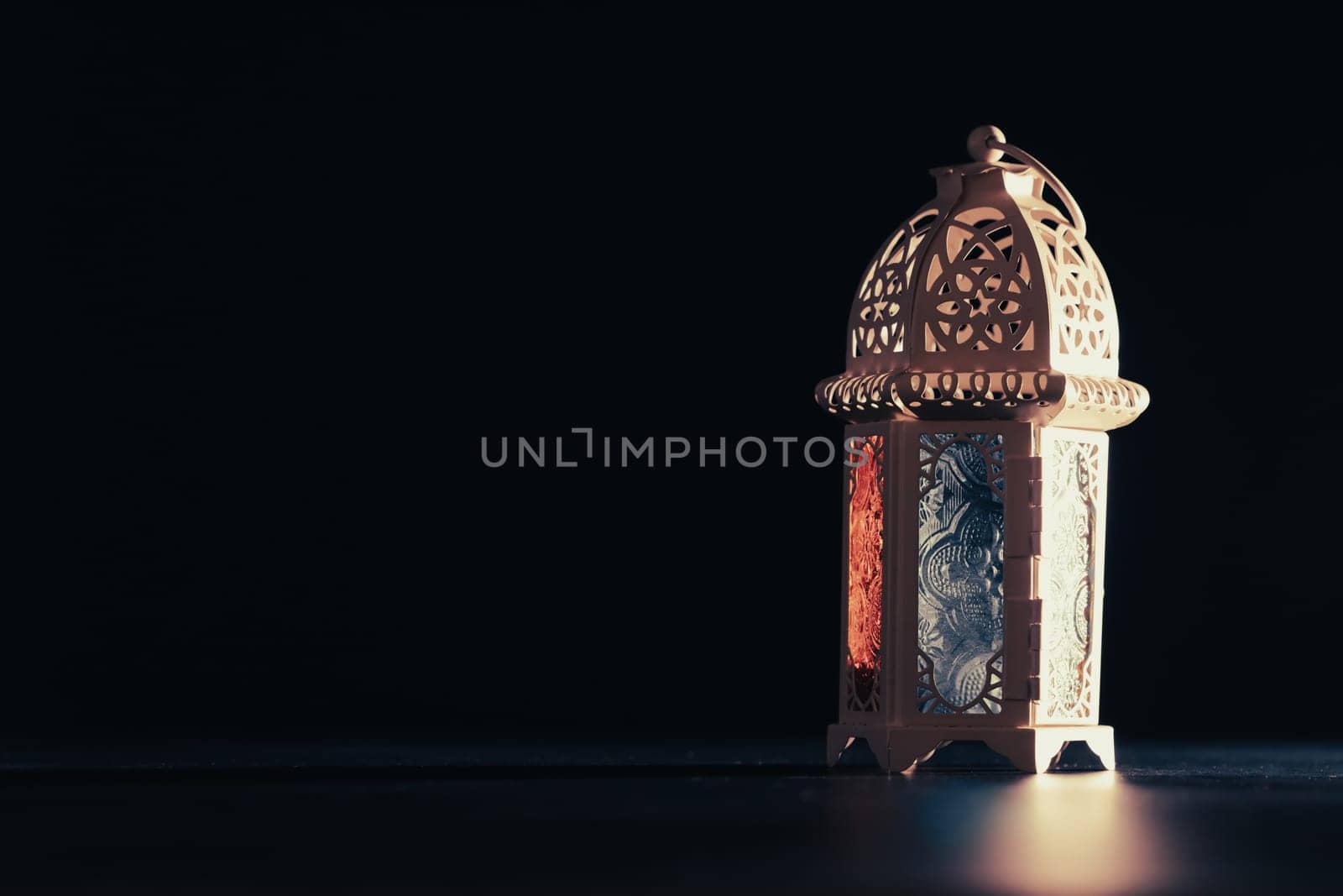 Ramadan Kareem background. Ornamental Arabic lantern glowing at night