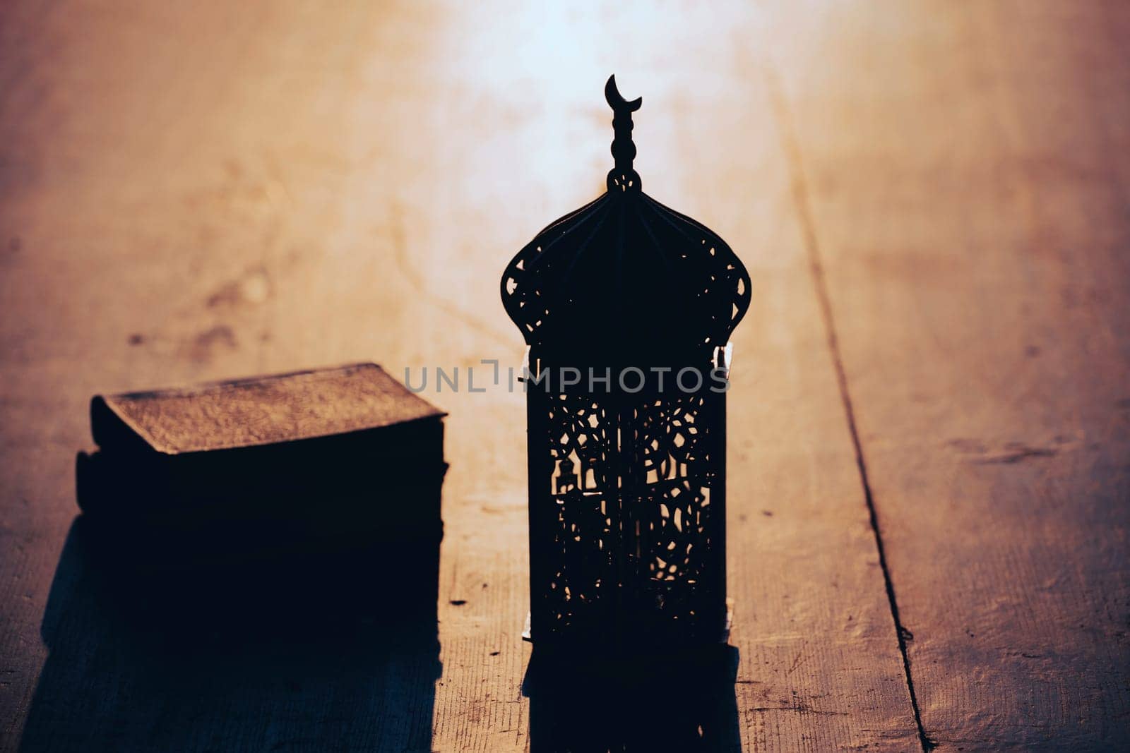 Ramadan Kareem background. Ornamental Arabic lantern on vintage wooden background in the sunset