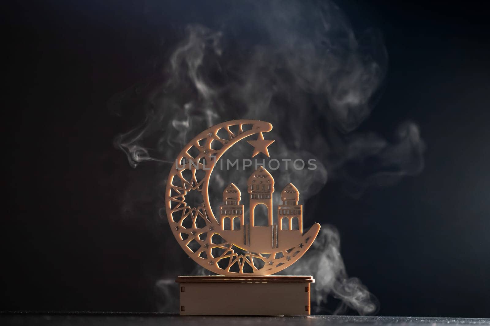 Ramadan Kareem background. Ornamental Arabic lantern glowing at night