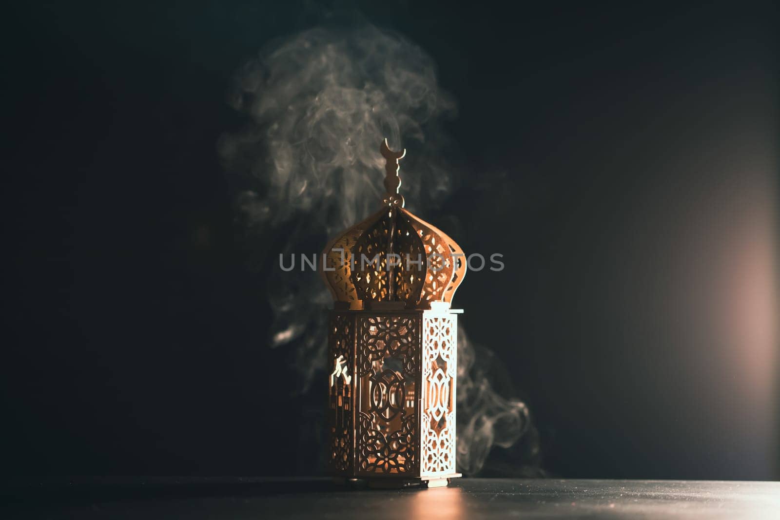 Ramadan Kareem background. Ornamental Arabic lantern glowing at night