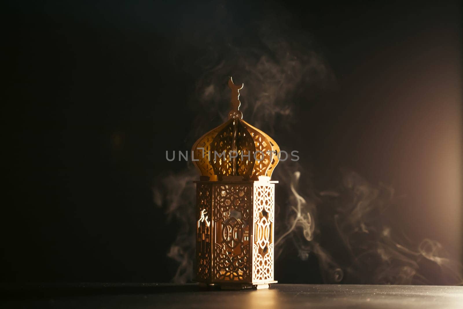 Ramadan Kareem background. Ornamental Arabic lantern glowing at night