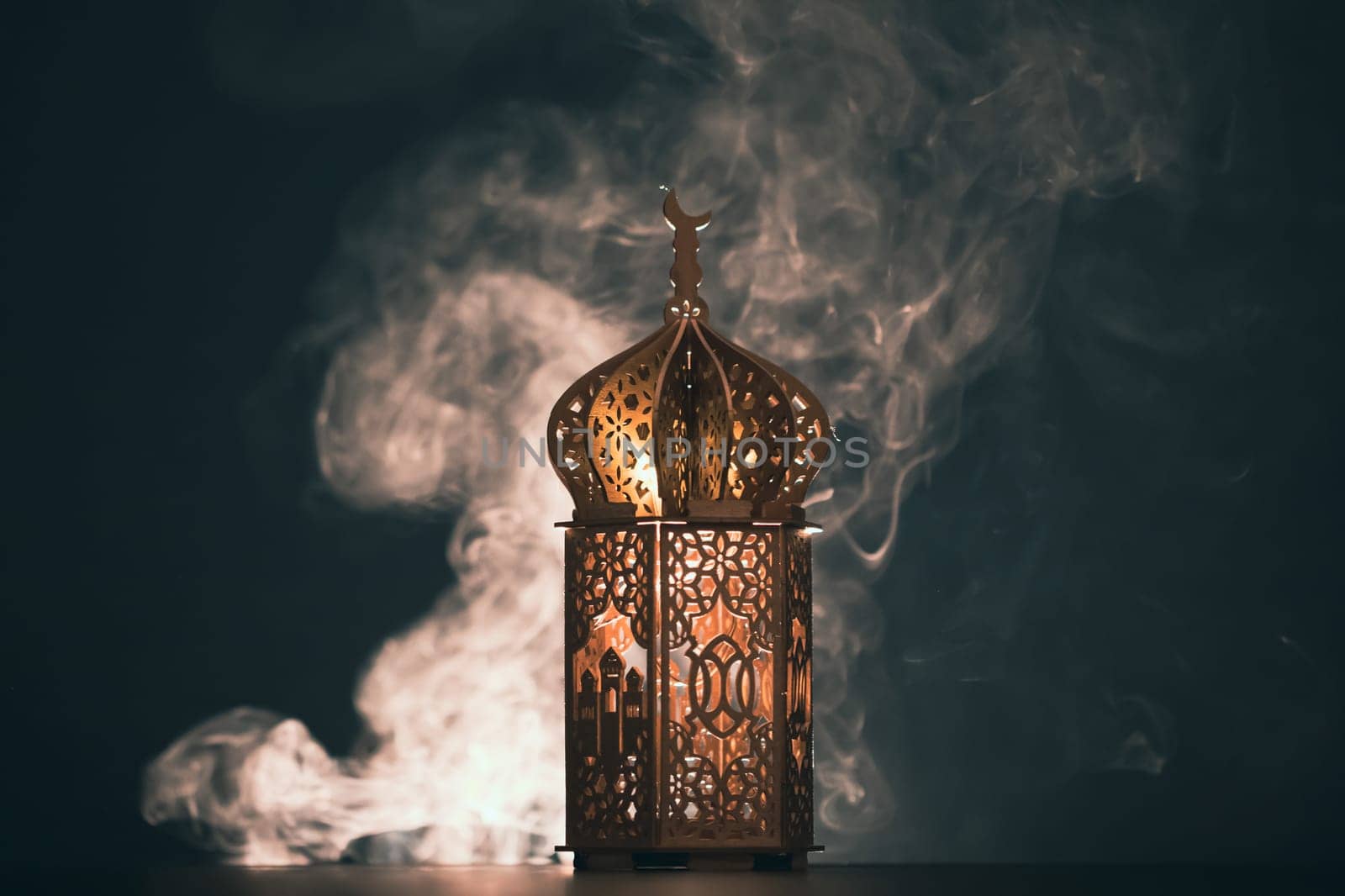 Ramadan Kareem background. Ornamental Arabic lantern glowing at night