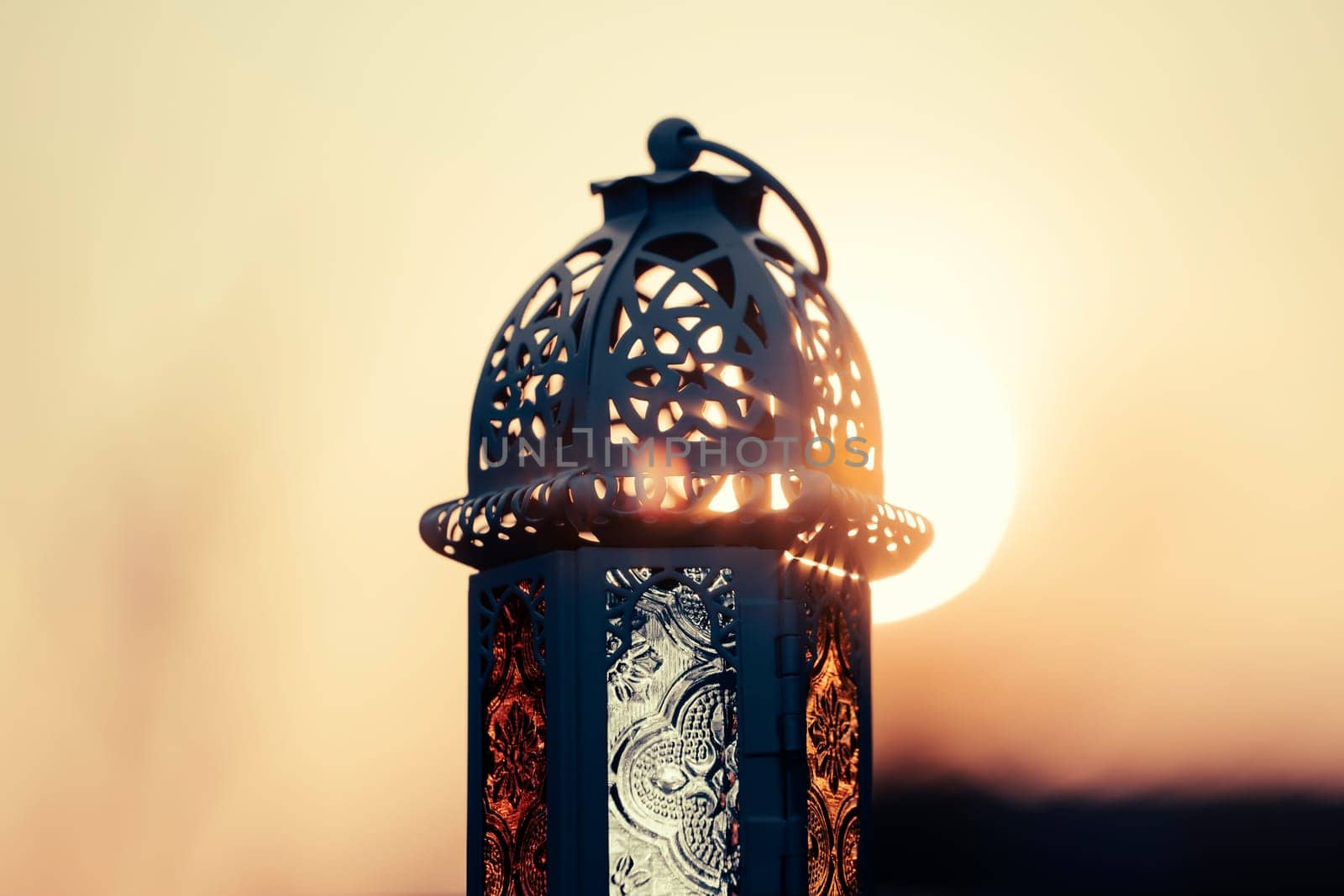 Ramadan Kareem background. Ornamental Arabic lantern in the sunset