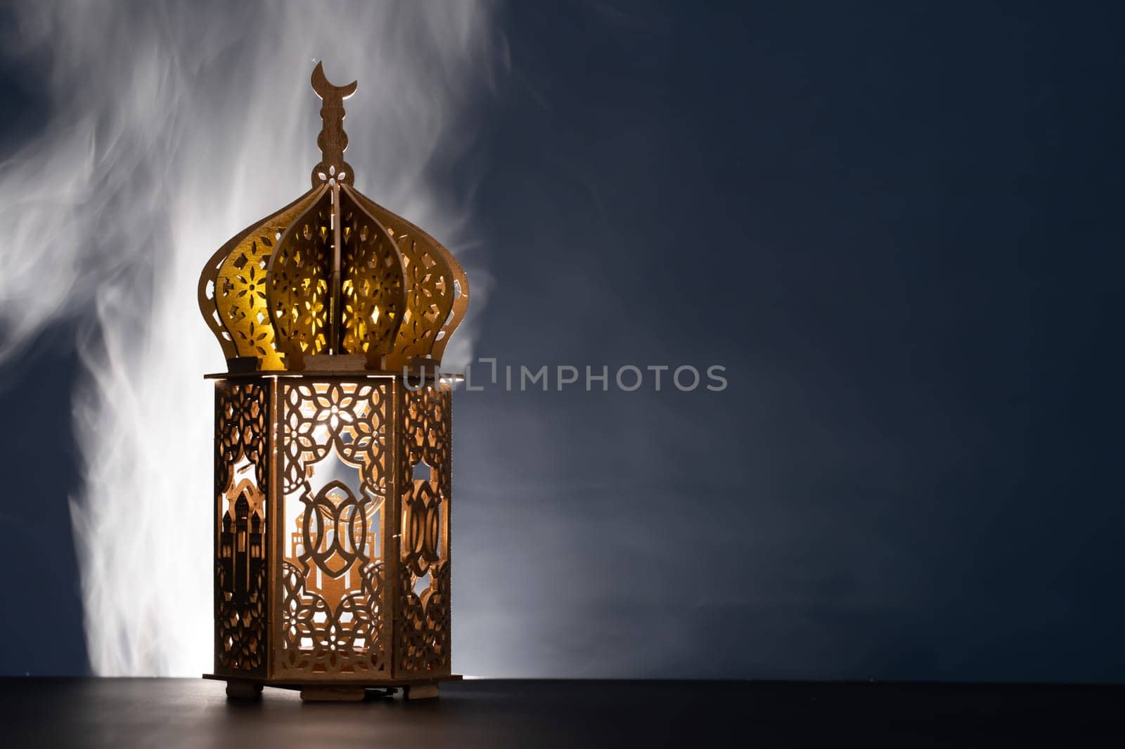 Ramadan Kareem background. Ornamental Arabic lantern glowing at night