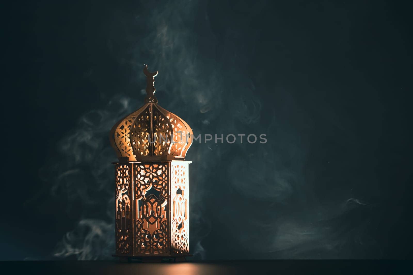 Ramadan Kareem background. Ornamental Arabic lantern glowing at night