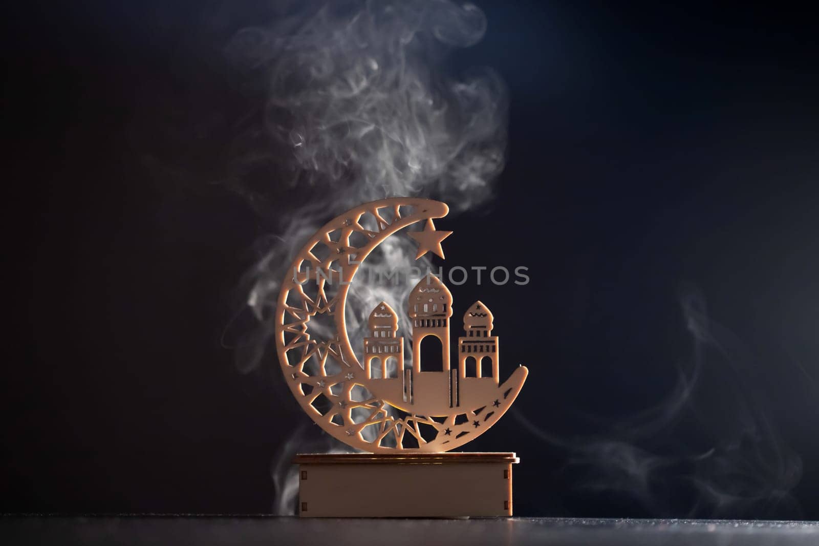 Ramadan Kareem background. Ornamental Arabic lantern glowing at night