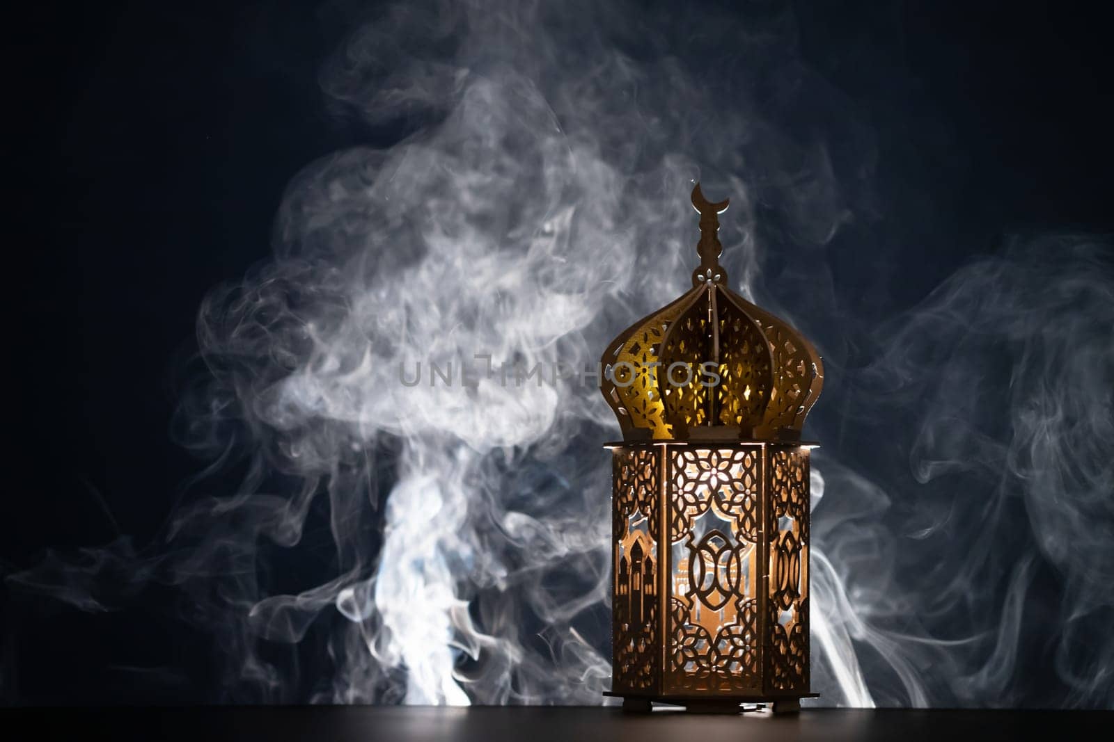 Ramadan Kareem background. Ornamental Arabic lantern glowing at night