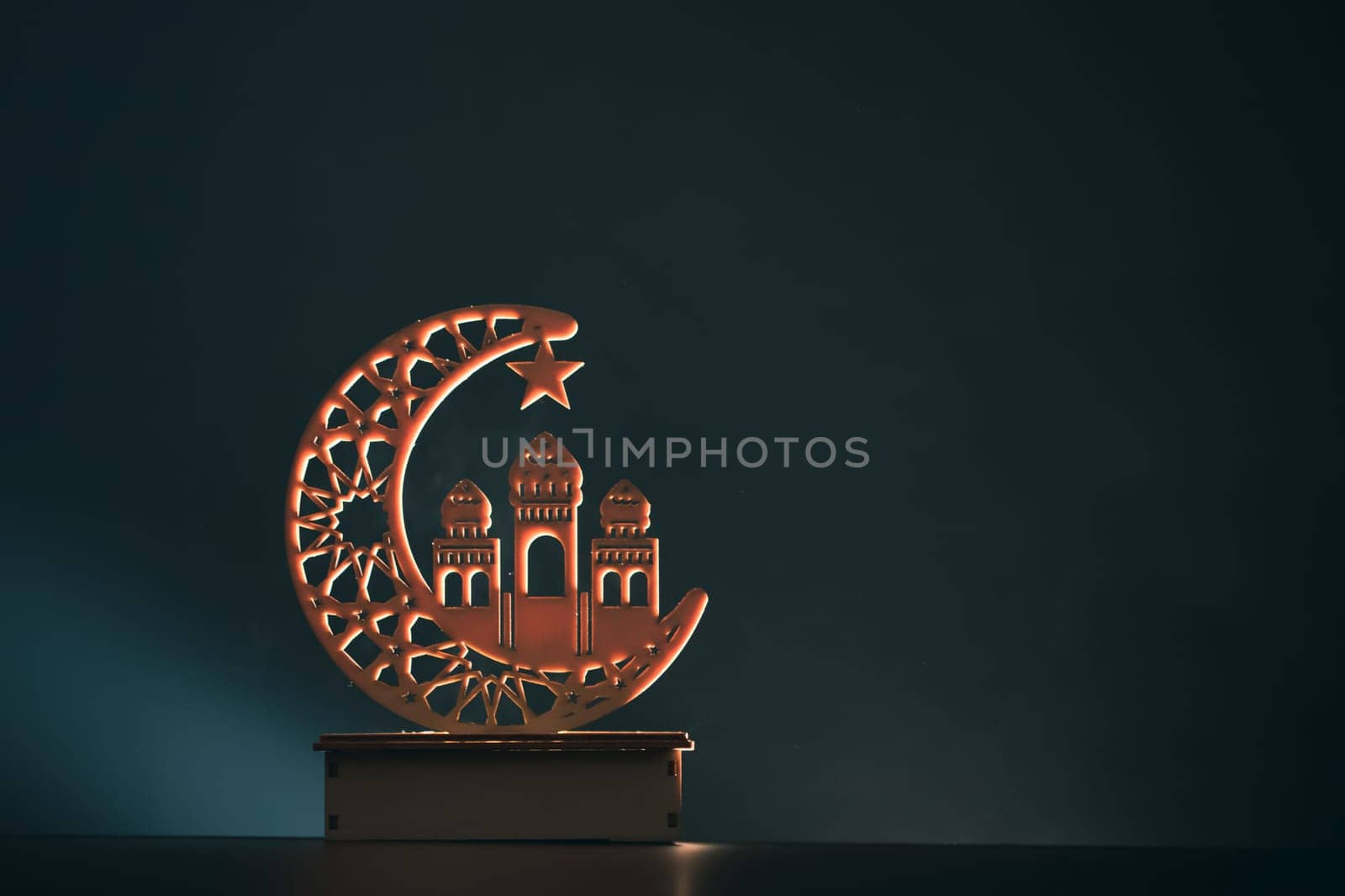 Ramadan Kareem background. Ornamental Arabic lantern glowing at night