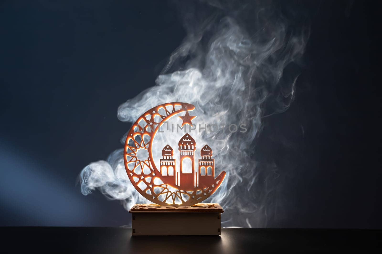 Ramadan Kareem background. Ornamental Arabic lantern glowing at night