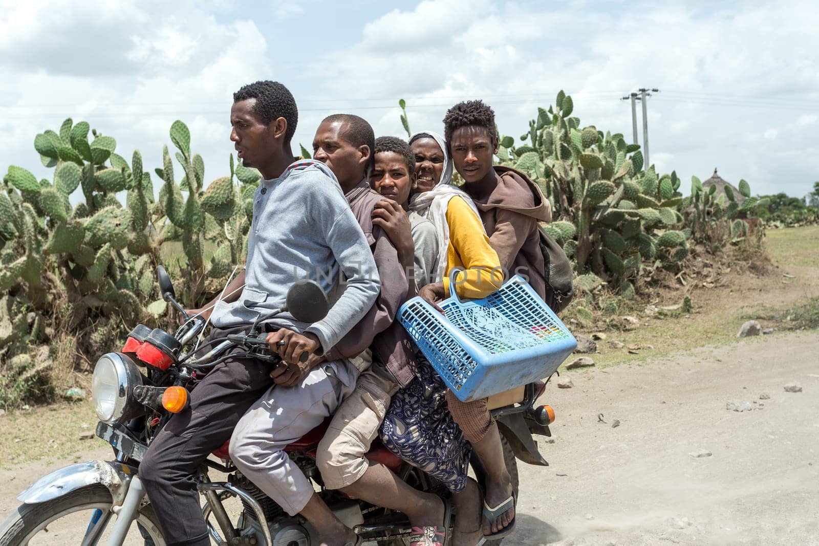 Oromia Region, Ethiopia - May 16, 2019: Ordinary people, family travel on bike in Ethiopian countryside. Everyday life on Ethiopia, Oromia Region, Ethiopia, Africa