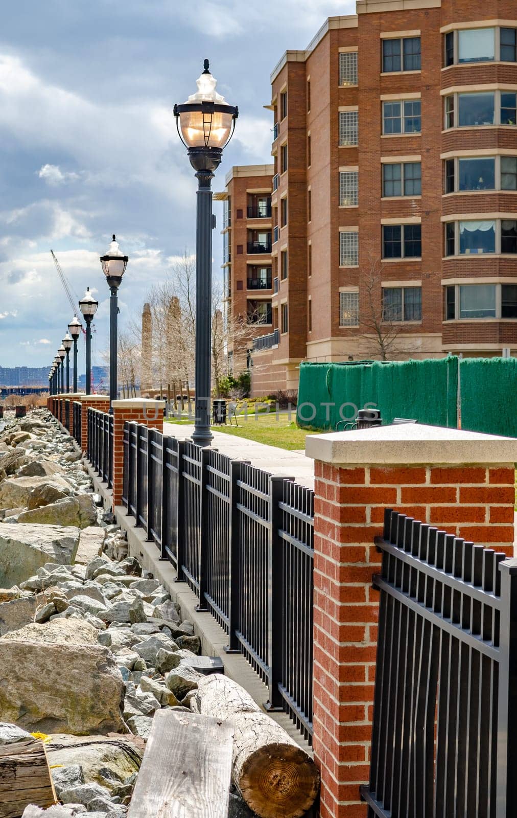 Residential Area at West New York, New Jersey, Fence with street lights at Hudson River, close-up during cloudy winter day, horizontal