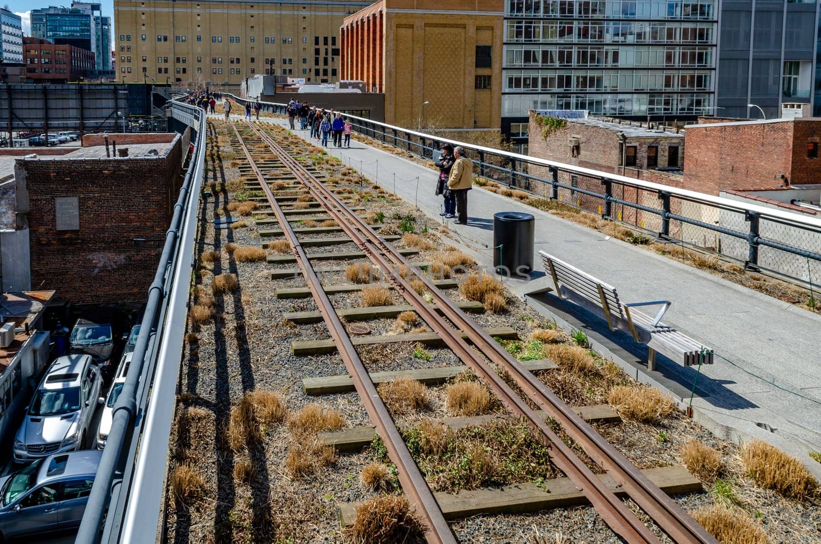 The High Line Rooftop Park aerial view, New York City with railroad track and People walking around during sunny winter day, horizontal