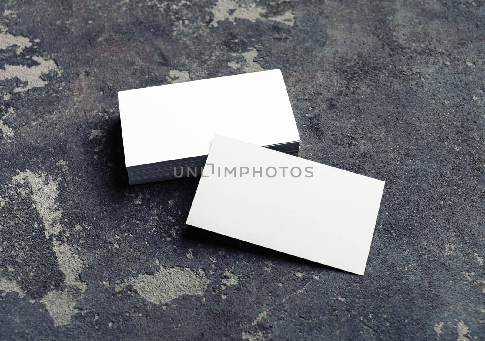 Photo of blank business cards on concrete background. Template for branding identity.