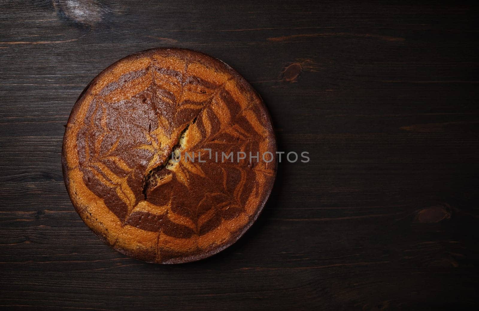 Sweet tasty pie on wooden background. Top view with copy space. Flat lay.