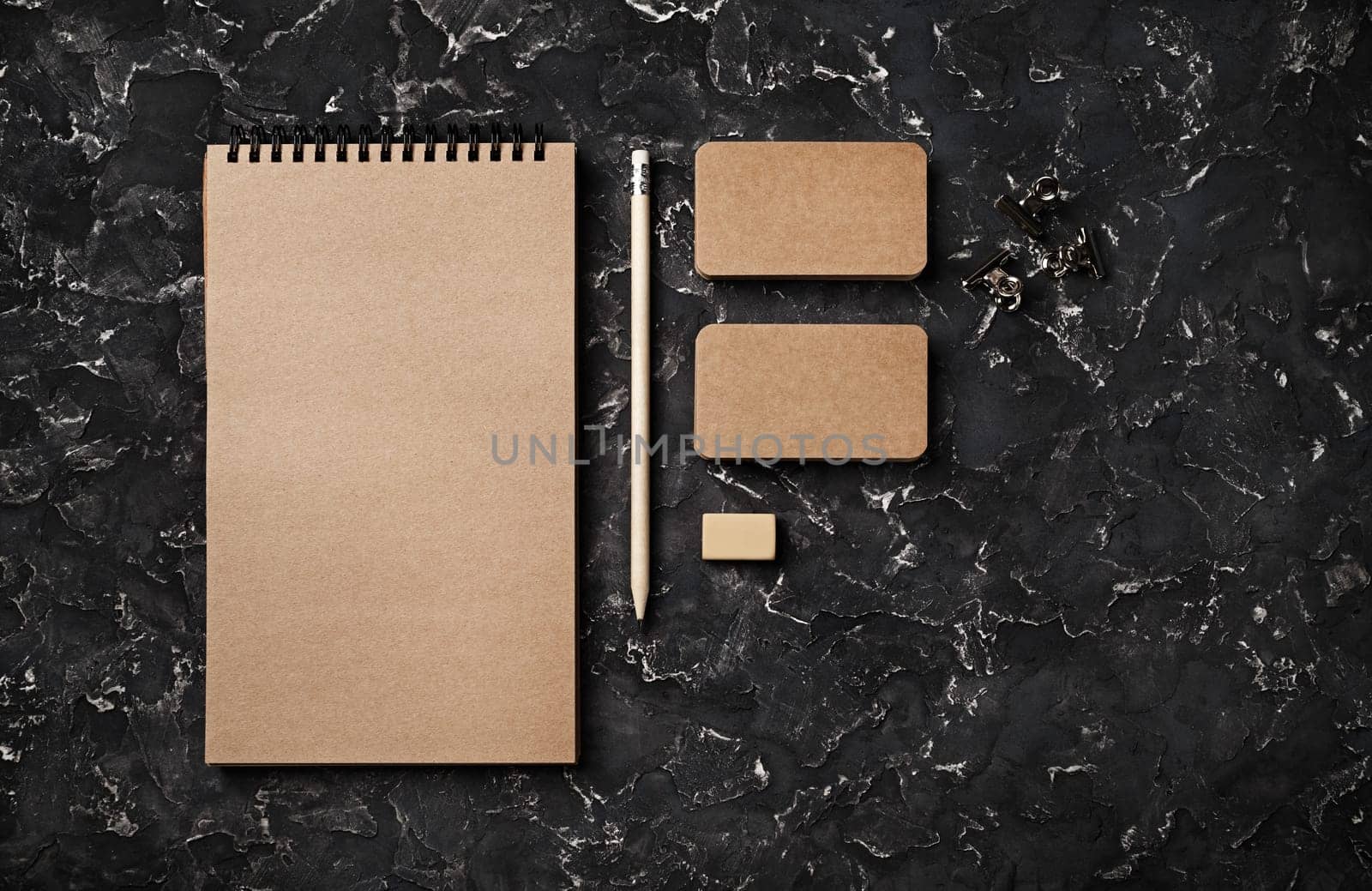 Kraft stationery template. Blank branding identity set on black plaster background. For design presentations and portfolios. Flat lay.