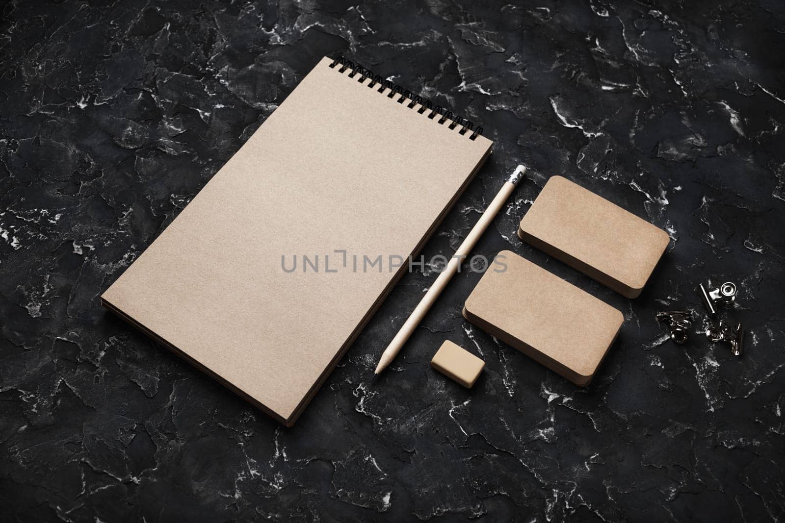 Blank kraft stationery set on black plaster background. Corporate identity template. Mock-up for branding identity for designers.