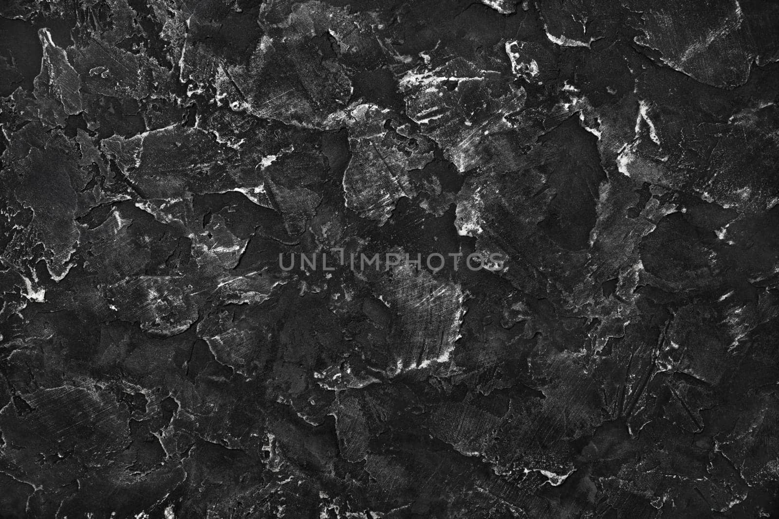 Black plaster background. Black stucco texture. Top view. Flat lay.