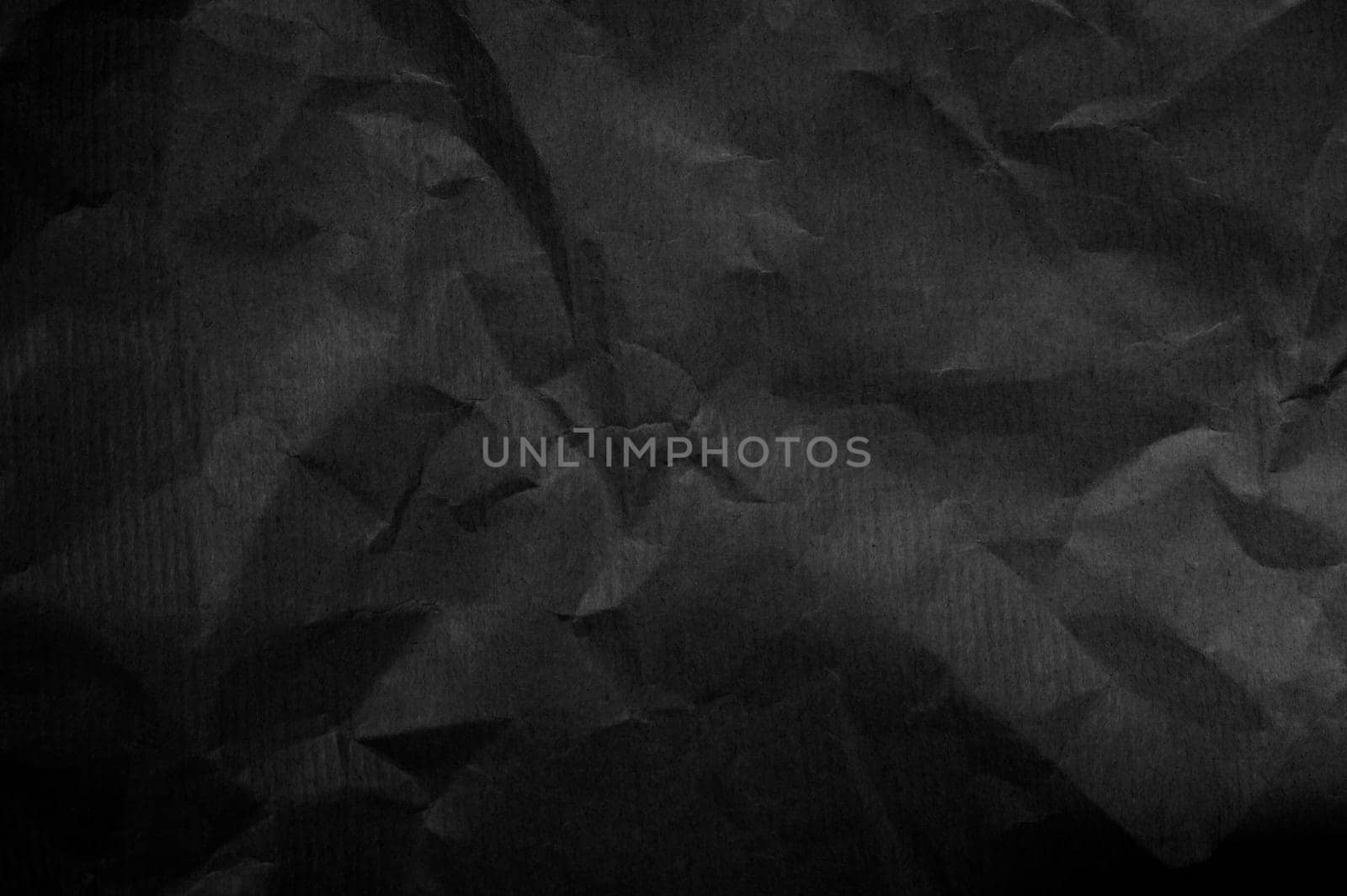 Wrinkled black paper background texture